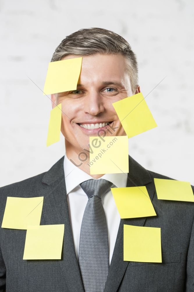 Portrait Of Mature Businessman Smiling With Yellow Adhesive Notes On