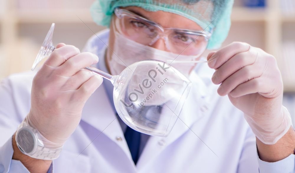 Forensic Investigator Working In Laboratory Examining Crime Evidence