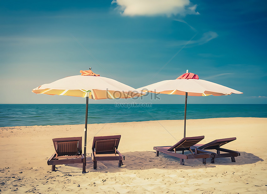 Two Beach Chairs And Umbrella On The Tropical Beach With Sea And Sky