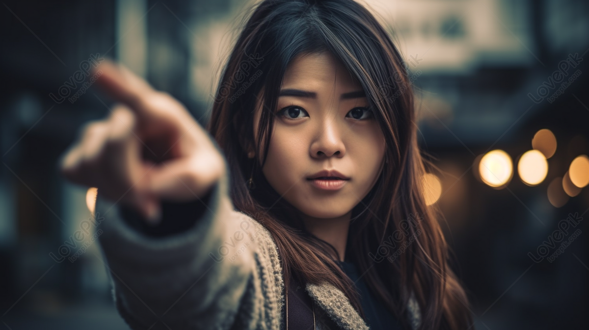 Asian Girl Pointing Up Against Dark Street Background, Pointing Up ...