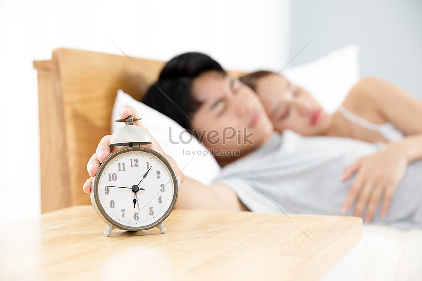 Sleeping Couple Presses The Alarm Clock Picture And Hd Photos Free