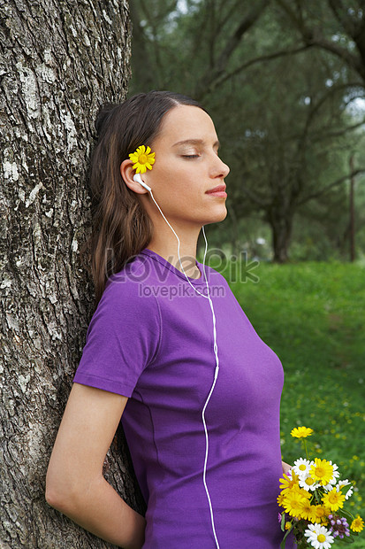 Woman Holding Flower Leaning Against Tree Picture And HD Photos | Free ...