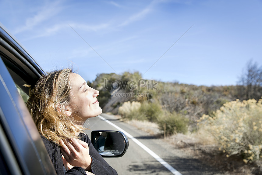 Side View Of Young Woman Looking Out Of Car Window With Eyes Clo ...