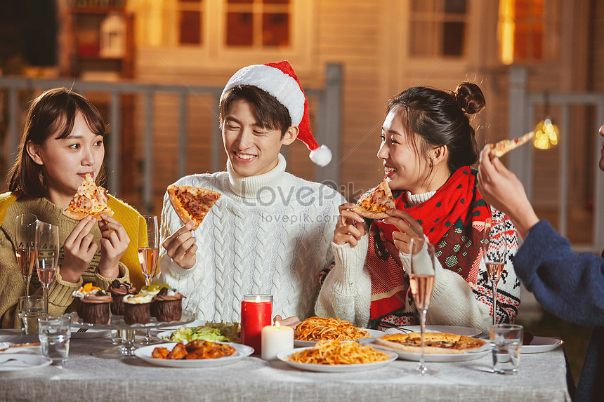 Young People Eating Pizza Together On Christmas Eve Picture And Hd 