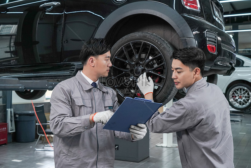 Car Maintenance Mechanics In The Workshop Communicate And Talk Picture ...