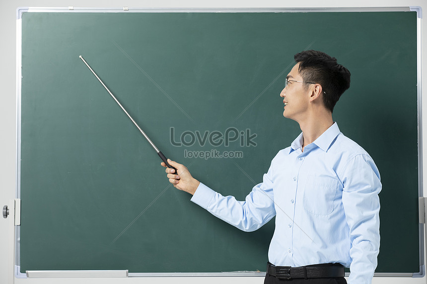 Male Teacher Giving Lecture In Front Of Blackboard Picture And HD ...