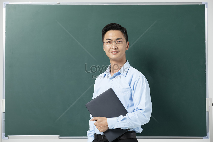 Male Teacher Giving Lecture In Front Of Blackboard Picture And HD ...