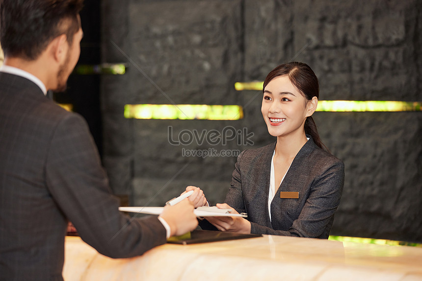 Hotel Front Desk Staff Check In For Customers Picture And HD Photos ...