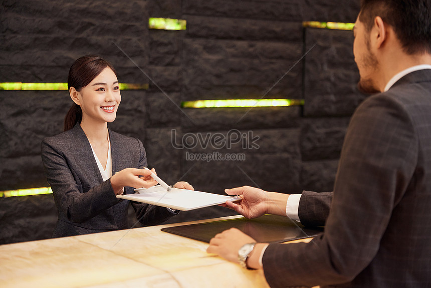 Hotel Front Desk Staff Check In For Customers Picture And HD Photos ...