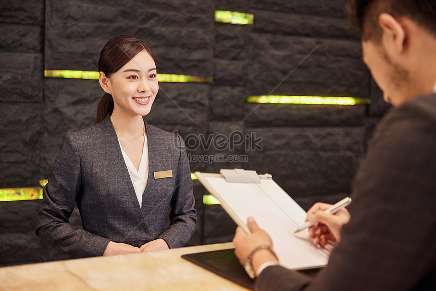 Hotel Front Desk Staff Check In For Customers Picture And HD Photos ...