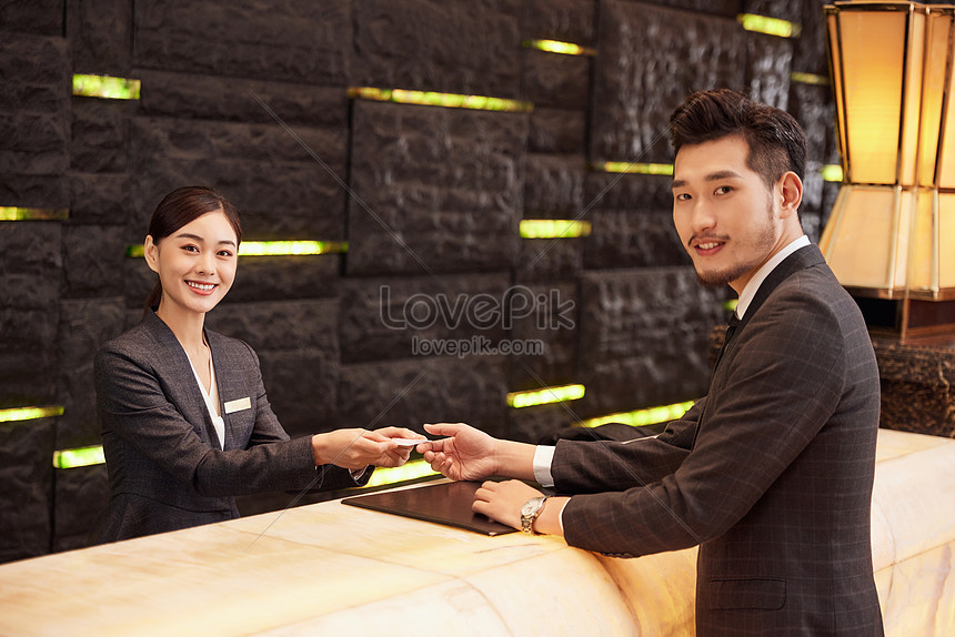 Hotel Front Desk Staff Check In For Customers Picture And HD Photos ...