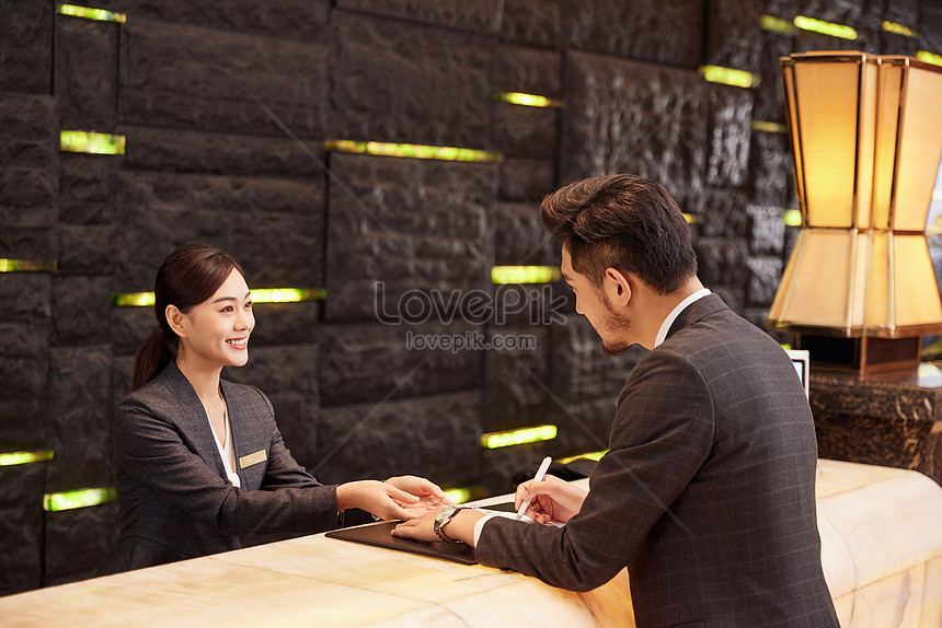 Hotel Front Desk Staff Check In For Customers Picture And HD Photos ...