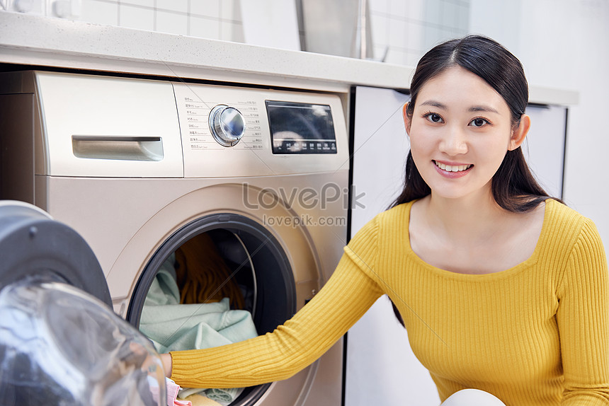 Housework Women Put Dirty Clothes In Washing Machine Picture And HD