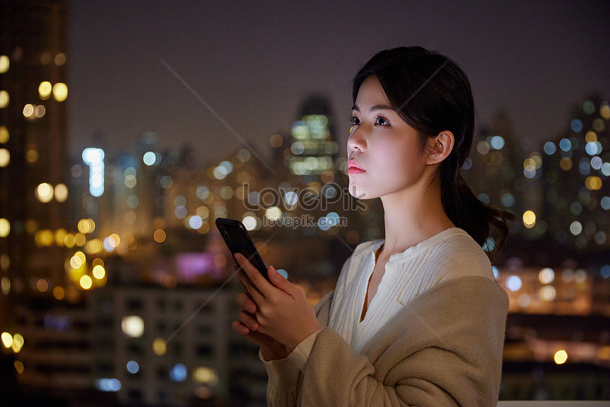 Young Women Staying Up Late At Night Playing With Mobile Phones Picture