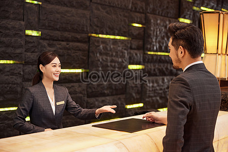 Hotel Front Desk Staff Check In For Customers Picture And HD Photos ...