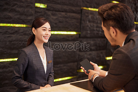 Hotel Front Desk Staff Check In For Customers Picture And HD Photos ...