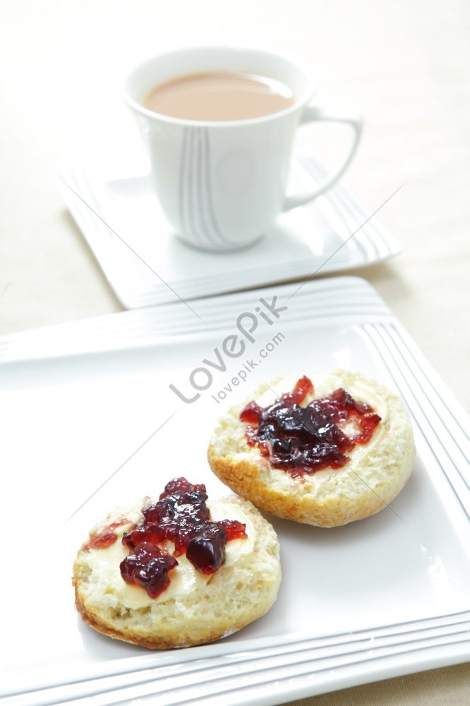 A Traditional English Afternoon Tea With A Sconed Topped With Butter ...