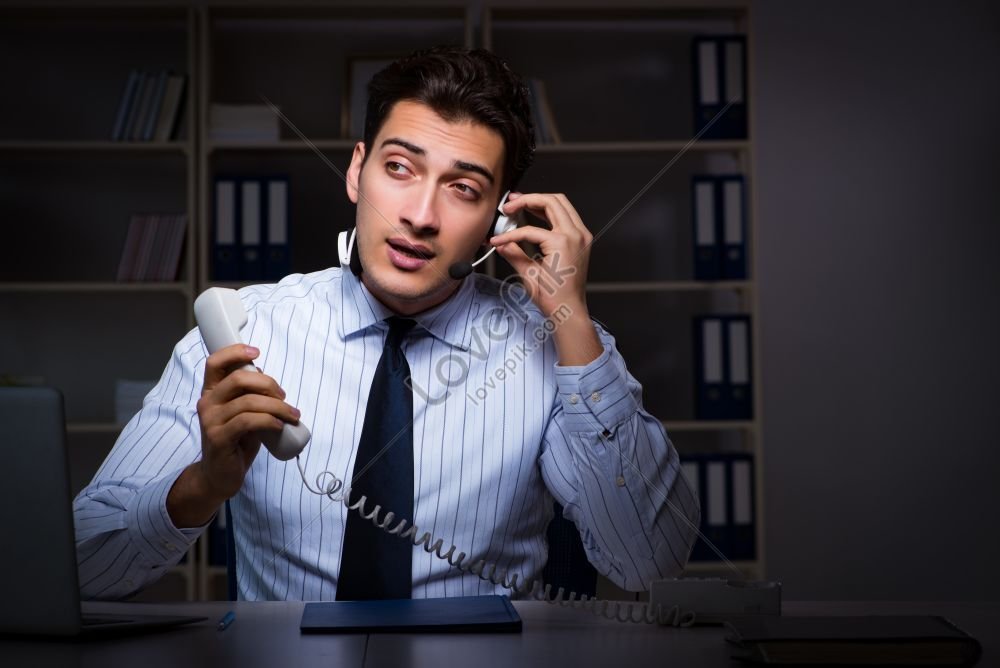 Call Center Operator Talking To Customer During Night Shift Photo ...