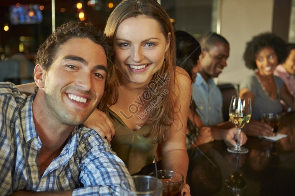 A Couple Enjoying Drinks With Friends At A Bar Picture And HD Photos ...