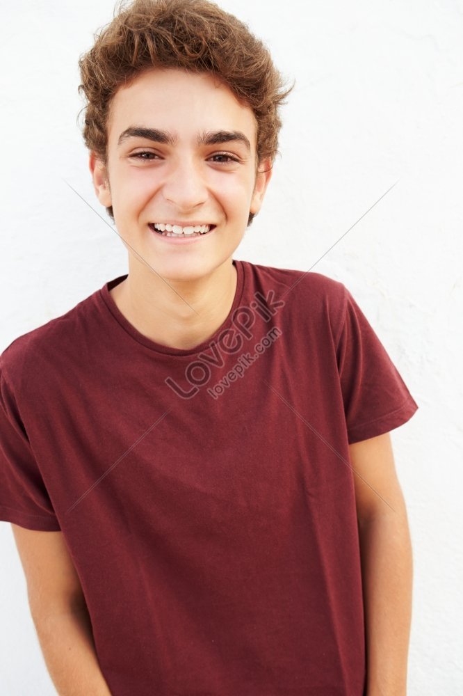 Portrait Of A Hispanic Teenage Boy Leaning Against A Wall Picture And ...