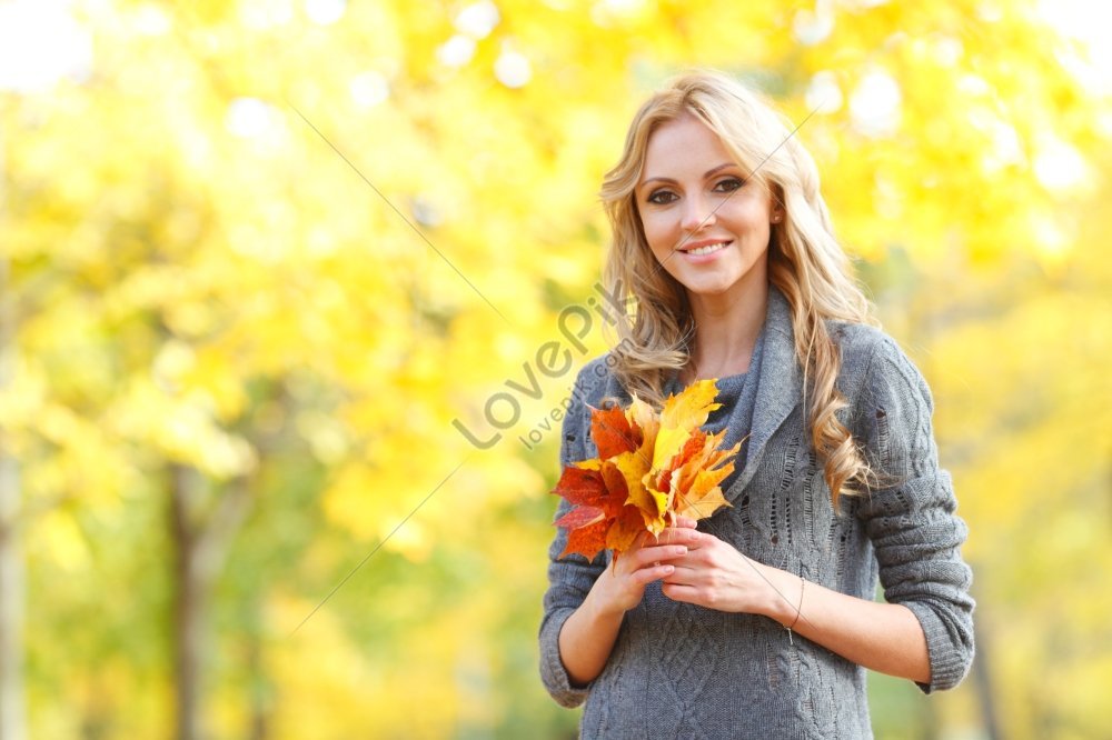 Portrait Of A Beautiful Blonde Woman Smiling In An Autumn Forest ...