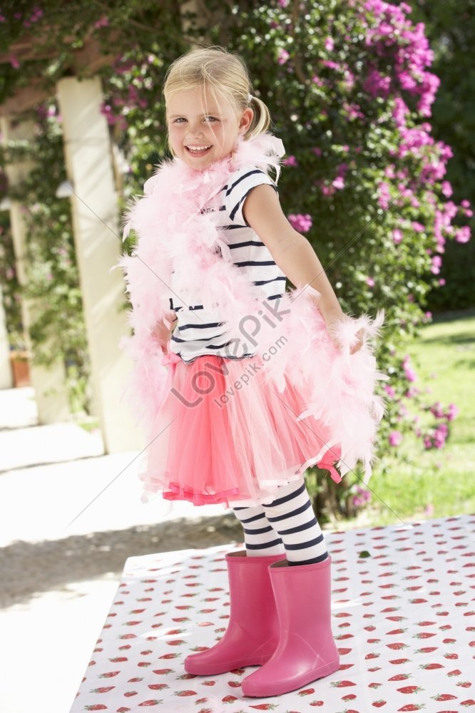 Young Girl Donning Pink Wellington Boots And A Feather Boa Picture And ...