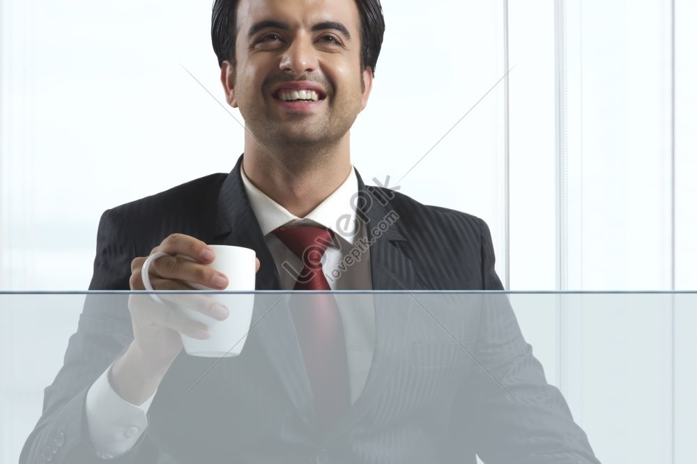 Happy Businessman Holding A Coffee Mug In An Office Picture Picture And ...