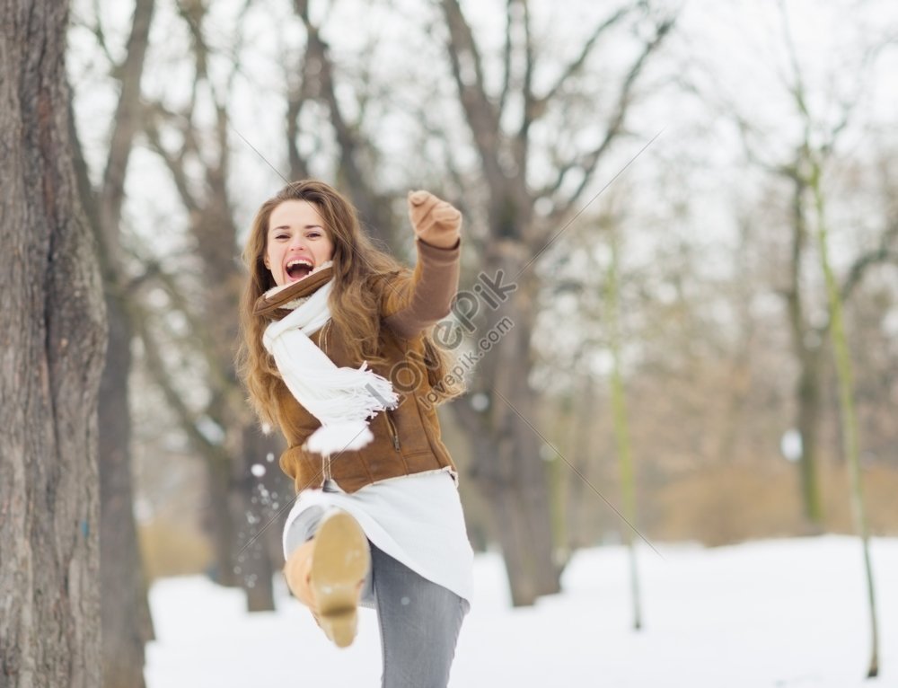 A Photo Of A Happy Young Woman Kicking Snow Picture And Hd Photos Free Download On Lovepik 