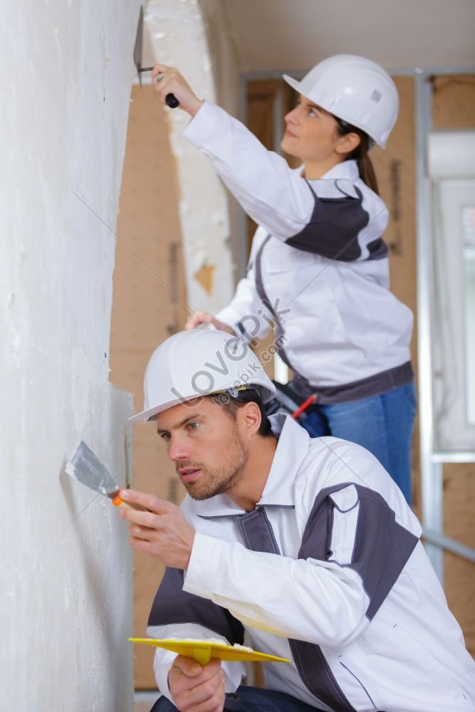 Male And Female Contractors Plastering An Interior Wall Photo Picture And HD Photos Free