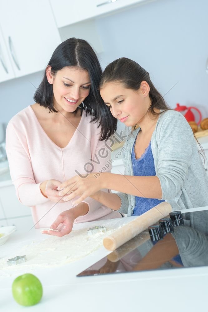 Mom And Daughter Cooking In The Kitchen For Mothers Day Picture Picture