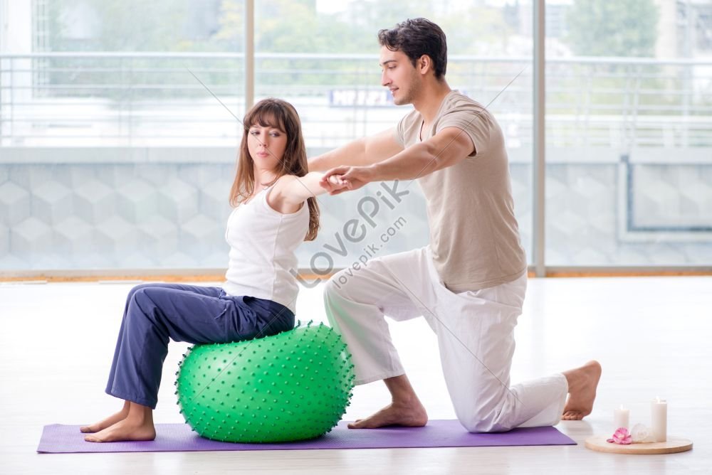 lovepik-personal-coach-helping-woman-in-gym-with-stability-ball-photo-image_352104528.jpg