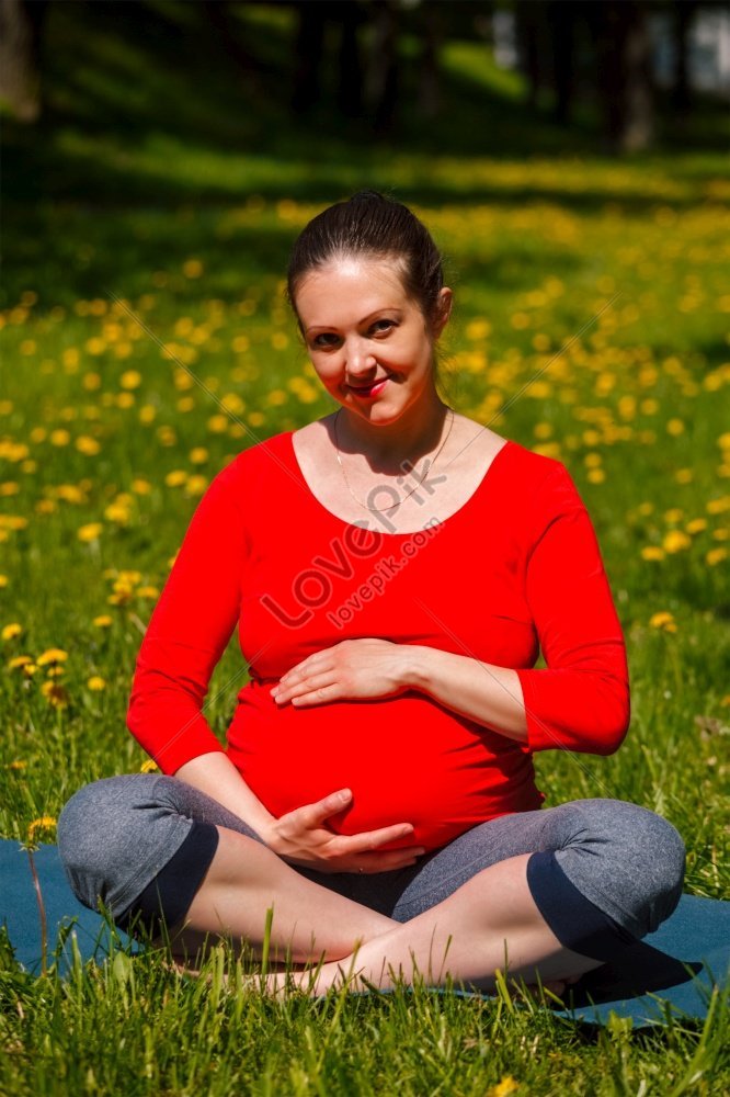 Premium Photo | Pregnant woman touching her belly meditation sitting in  lotus pose at home pregnancy yoga