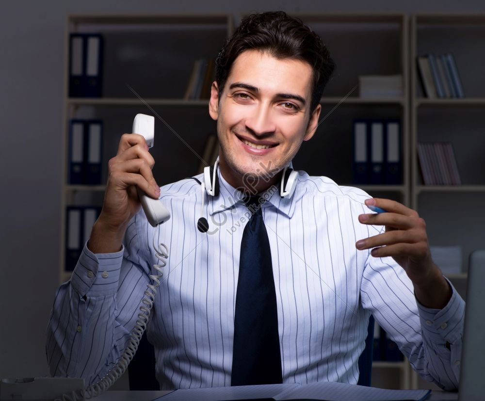 photo-of-call-center-operator-conversing-with-customer-during-night