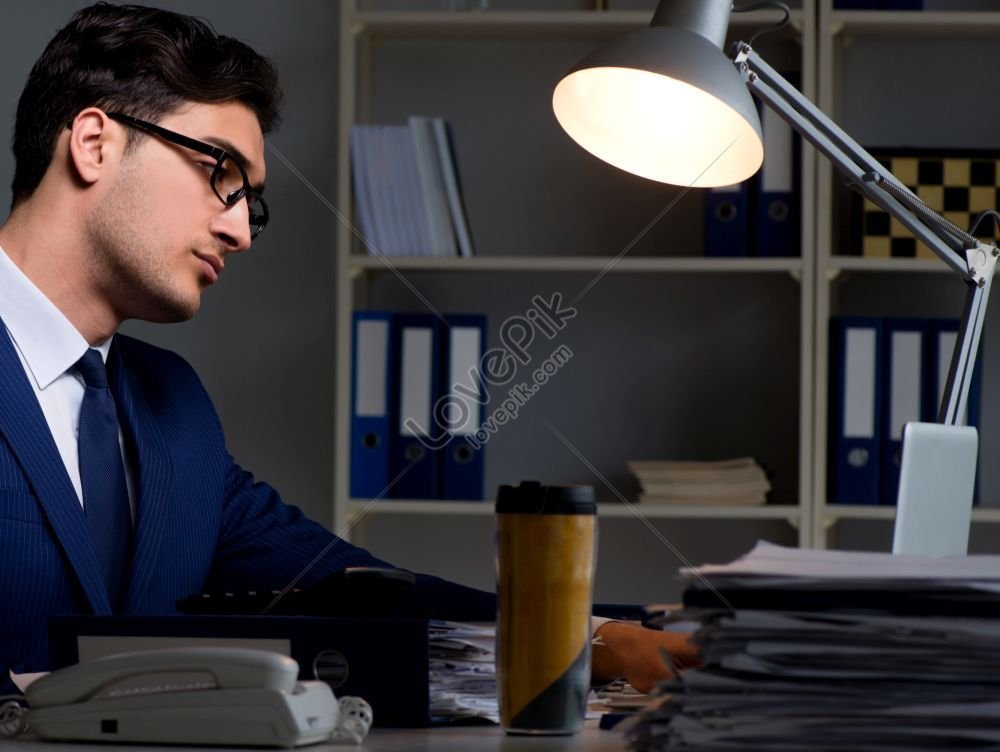 employee working late to complete crucial assigned task photo, unhappy, desk, missing HD Photo