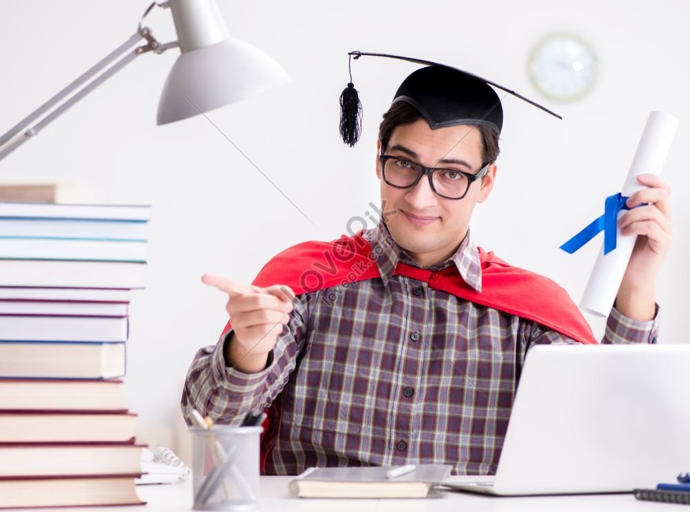 The Superhero Student Studying While Wearing A Mortarboard A Photo ...