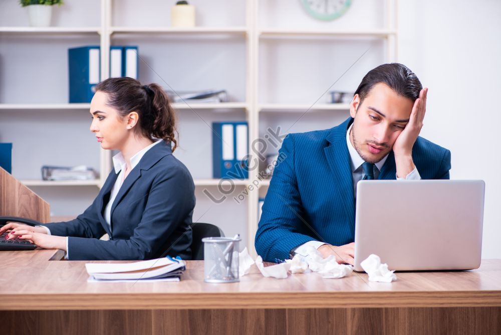 Photo Of Two Employees Experiencing Hardship At Work Picture And HD ...