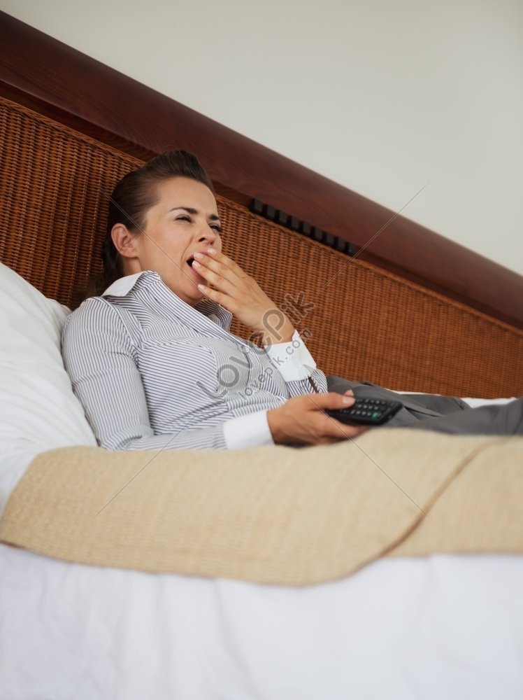 Young Businesswoman Lying On Bed In Hotel Room Watching Tv Picture And Hd Photos Free Download 