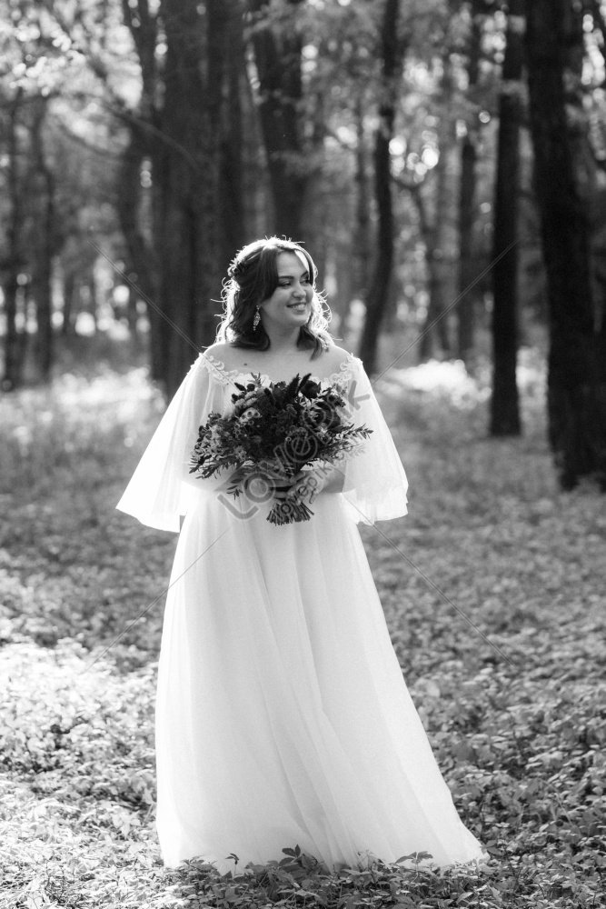 Girl Wearing Wedding Dress In Autumn Forest Against Wild Trees ...