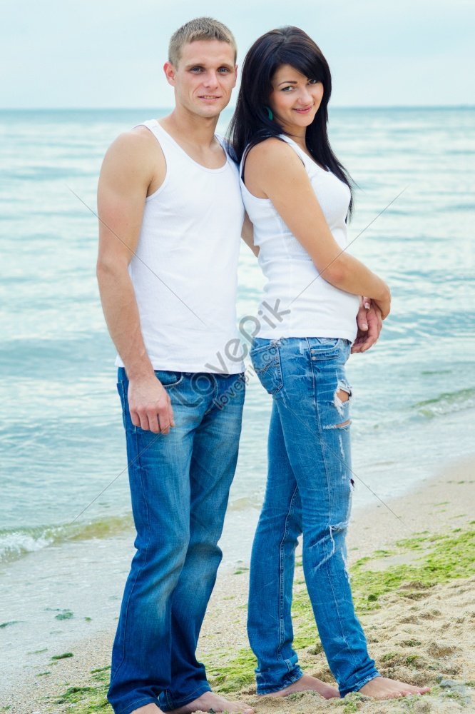Парень и девушка кружатся на берегу моря