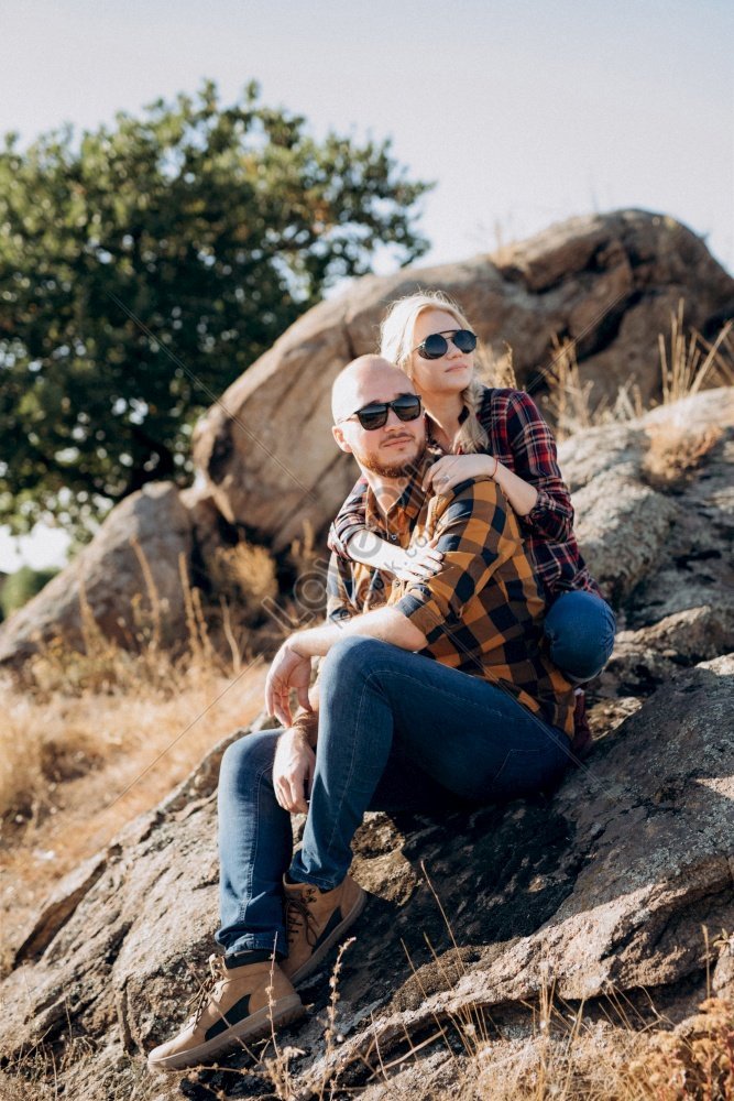 Guy And Girl Wearing Caged Shirts And Trekking Shoes Standing On Granite Rocks In Photo Picture