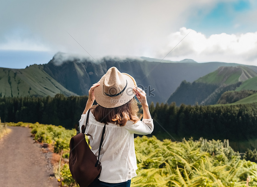 woman traveler holding hat and looking at amazing mountains and forest. Generative AI, travel,  nature,  summer HD Photo