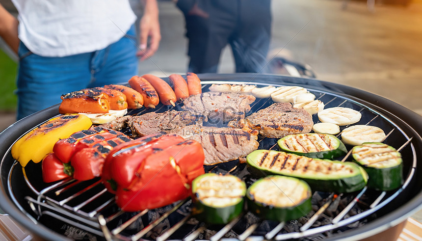 Barbeque Grill With Delicious Grilled Meat And Vegetables On Blurred ...