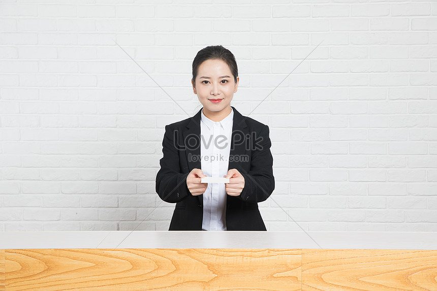 Business Women Present Business Cards At The Front Desk Photo