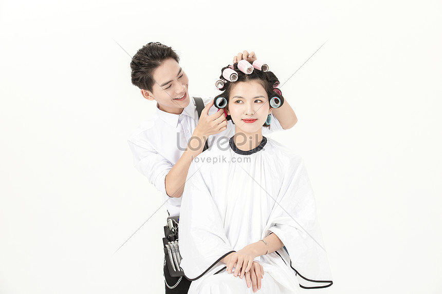 The Hairdresser Uses Hair Curls To Give Customers Hot Curls Photo