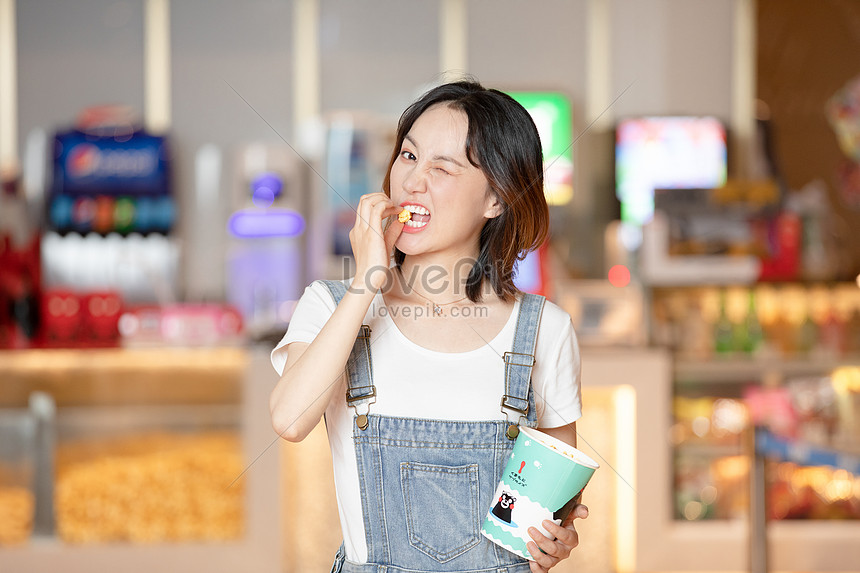 Cute Beauty Eating Popcorn At The Entrance Of The Cinema Photo Image Picture Free Download Lovepik Com