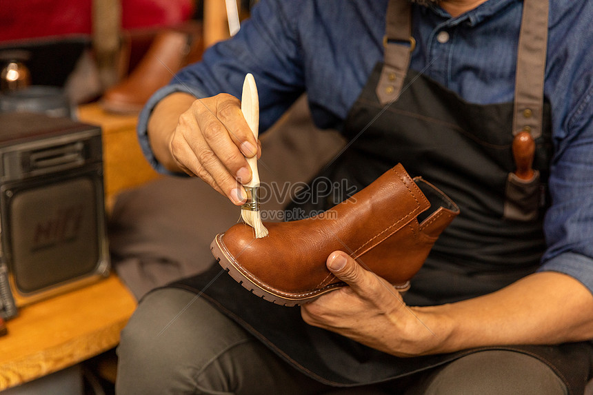 Male shoemaker taking care of leather 