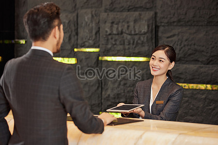 Hotel Front Desk Staff Check In For Customers Picture And HD Photos ...