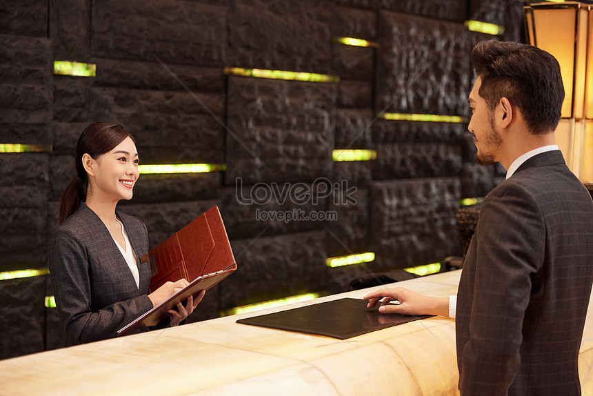 Hotel Front Desk Staff Check In For Customers Picture And HD Photos ...