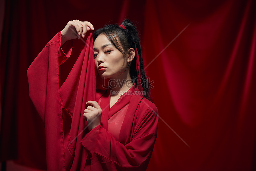 Chinese Style Beauty In Ancient Costume Hides Her Face With Sleeves 