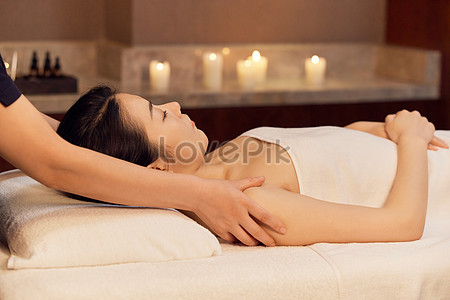 Professional male masseur massages neck and shoulders of young woman in  massage parlor., Stock image